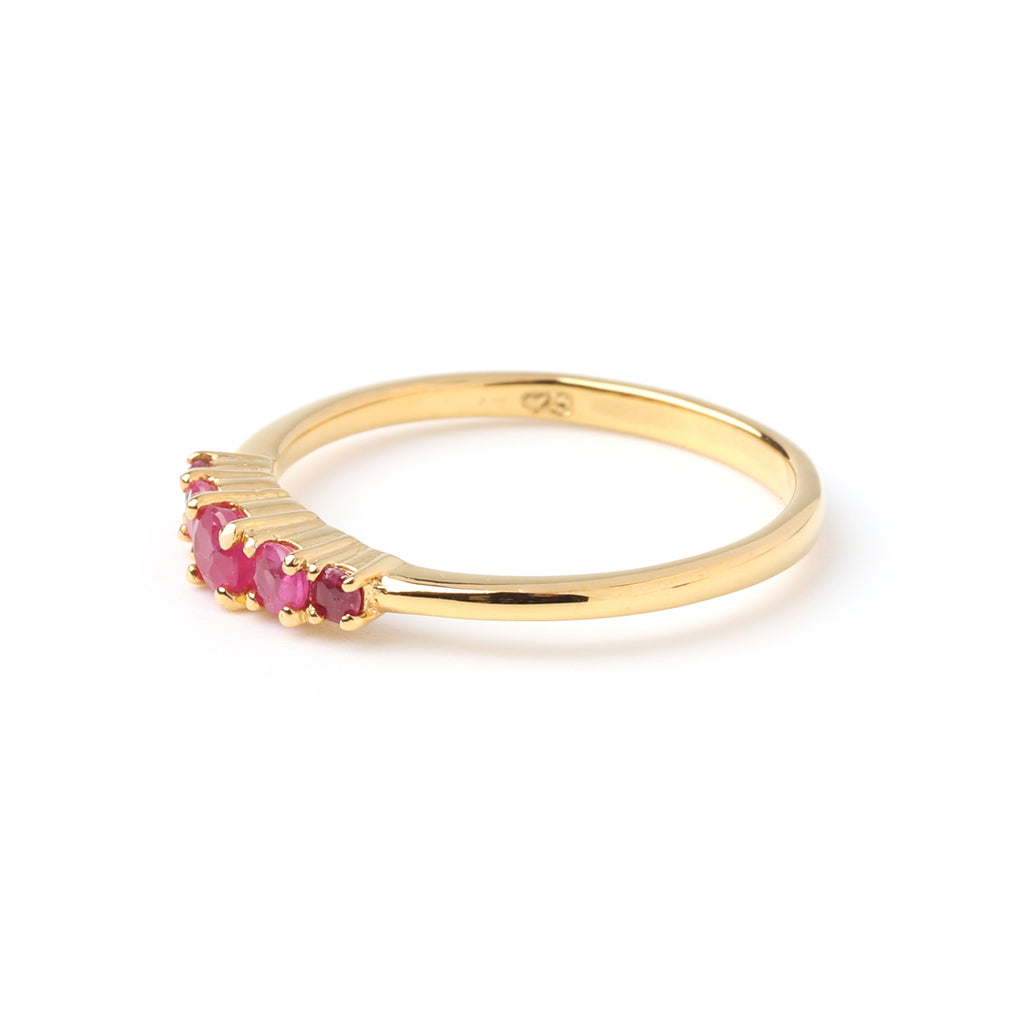 Detail view of ruby gemstones prong-set on slim 925 sterling silver gold ring