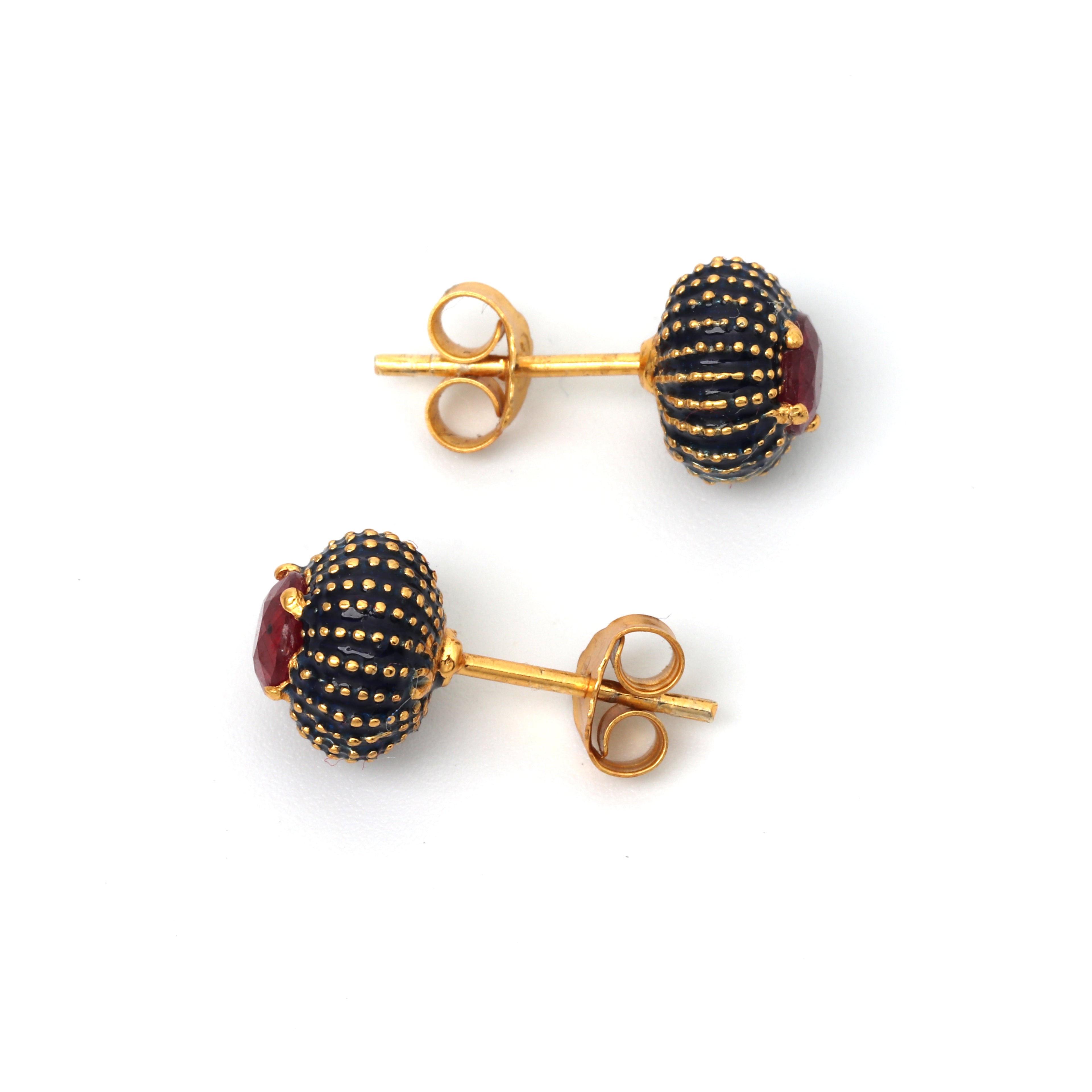 Elegant red ruby stud earrings with textured black enamel accents