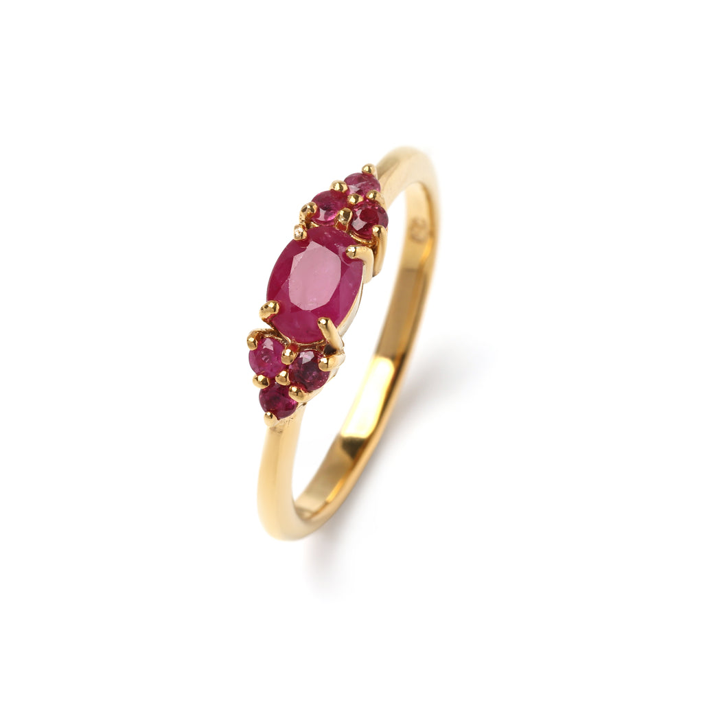 Close-up of ruby cluster ring in 925 sterling silver with gold finish, prong-set gemstones by Jewelry by Crimson