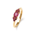 Close-up of ruby cluster ring in 925 sterling silver with gold finish, prong-set gemstones by Jewelry by Crimson