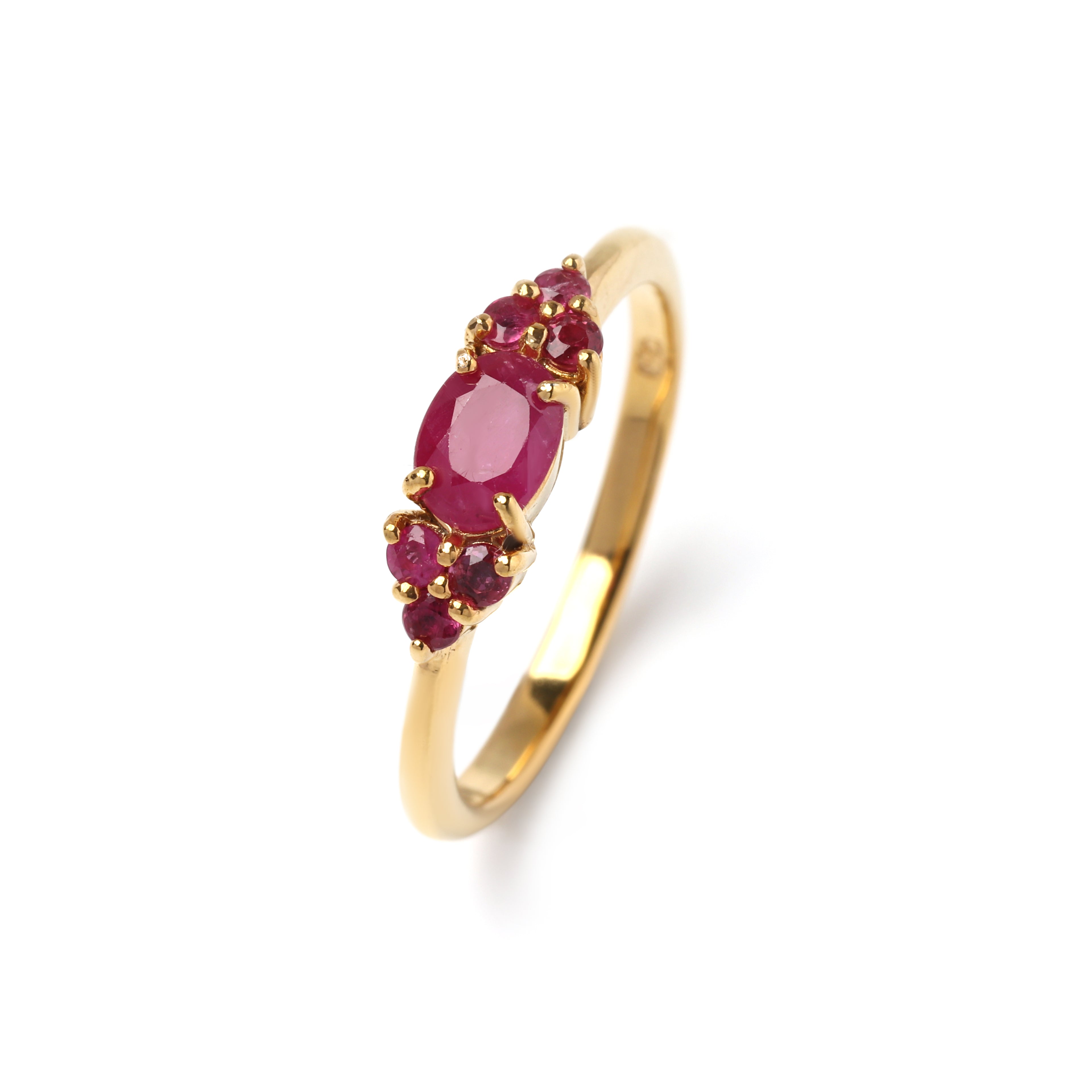 Close-up of ruby cluster ring in 925 sterling silver with gold finish, prong-set gemstones by Jewelry by Crimson