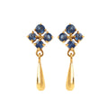 Close-up of 925 sterling silver sapphire drop earrings with prong-set blue sapphires and gold finish by Jewelry by Crimson