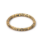 Gold textured ring with black accents, elegant handcrafted design