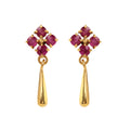 Close-up of ruby drop earrings in 925 sterling silver with gold finish, floral cluster setting by Jewelry by Crimson