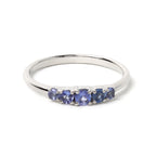 Sterling silver ring with five round blue tanzanite gemstones, elegant band design