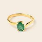 Gold ring with oval emerald gemstone, elegant solitaire design for women