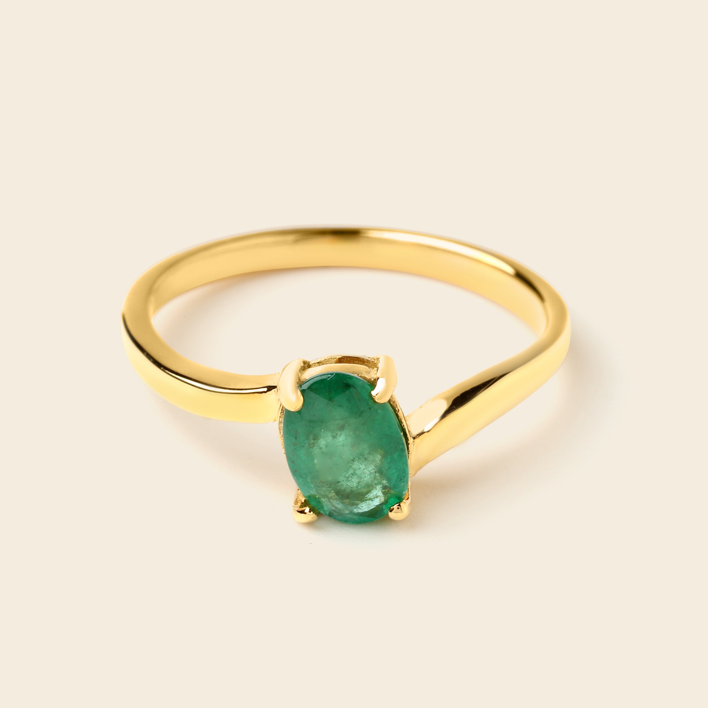 Gold ring with oval emerald gemstone, elegant solitaire design for women