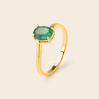 Gold ring with oval emerald gemstone, elegant solitaire design for women
