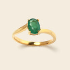 Gold ring with oval emerald gemstone, elegant solitaire design