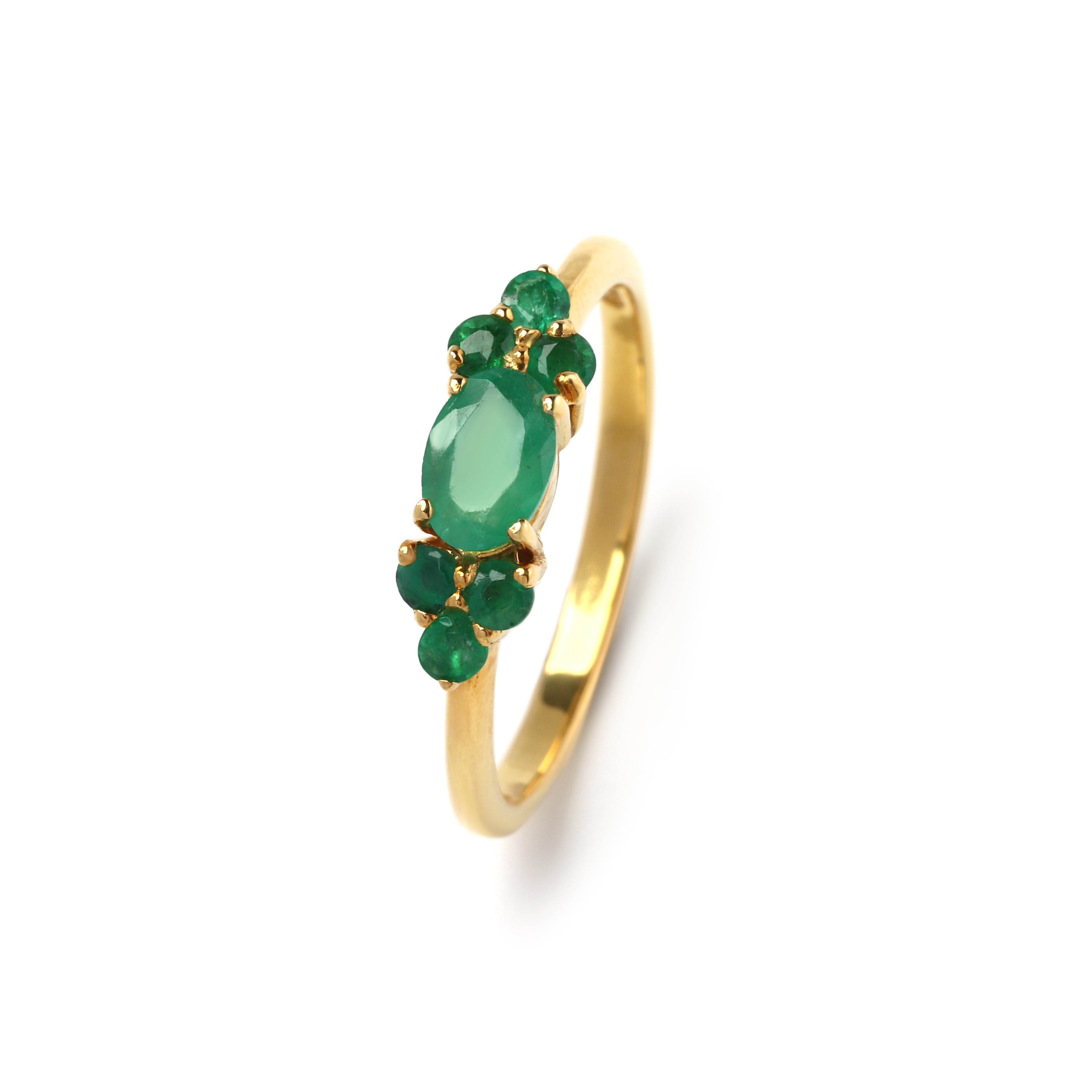 Close-up of emerald cluster ring in 925 sterling silver with gold finish, prong-set gemstones by Jewelry by Crimson