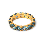 Gold-tone ring with blue topaz gemstones, 925 sterling silver band, elegant stackable design