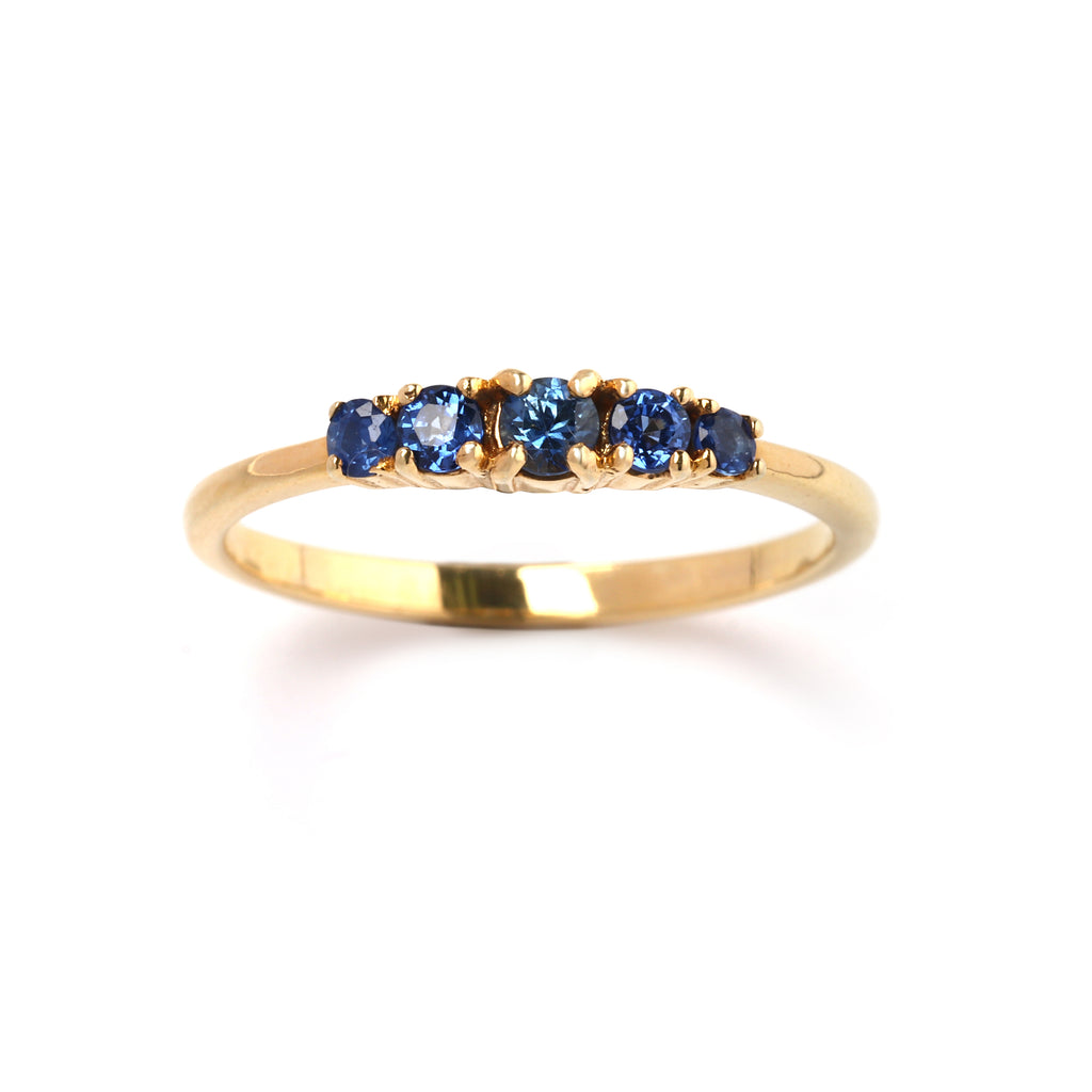 Close-up of 925 sterling silver blue sapphire ring with gold finish prong setting by Jewelry by Crimson