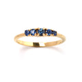 Close-up of 925 sterling silver blue sapphire ring with gold finish prong setting by Jewelry by Crimson