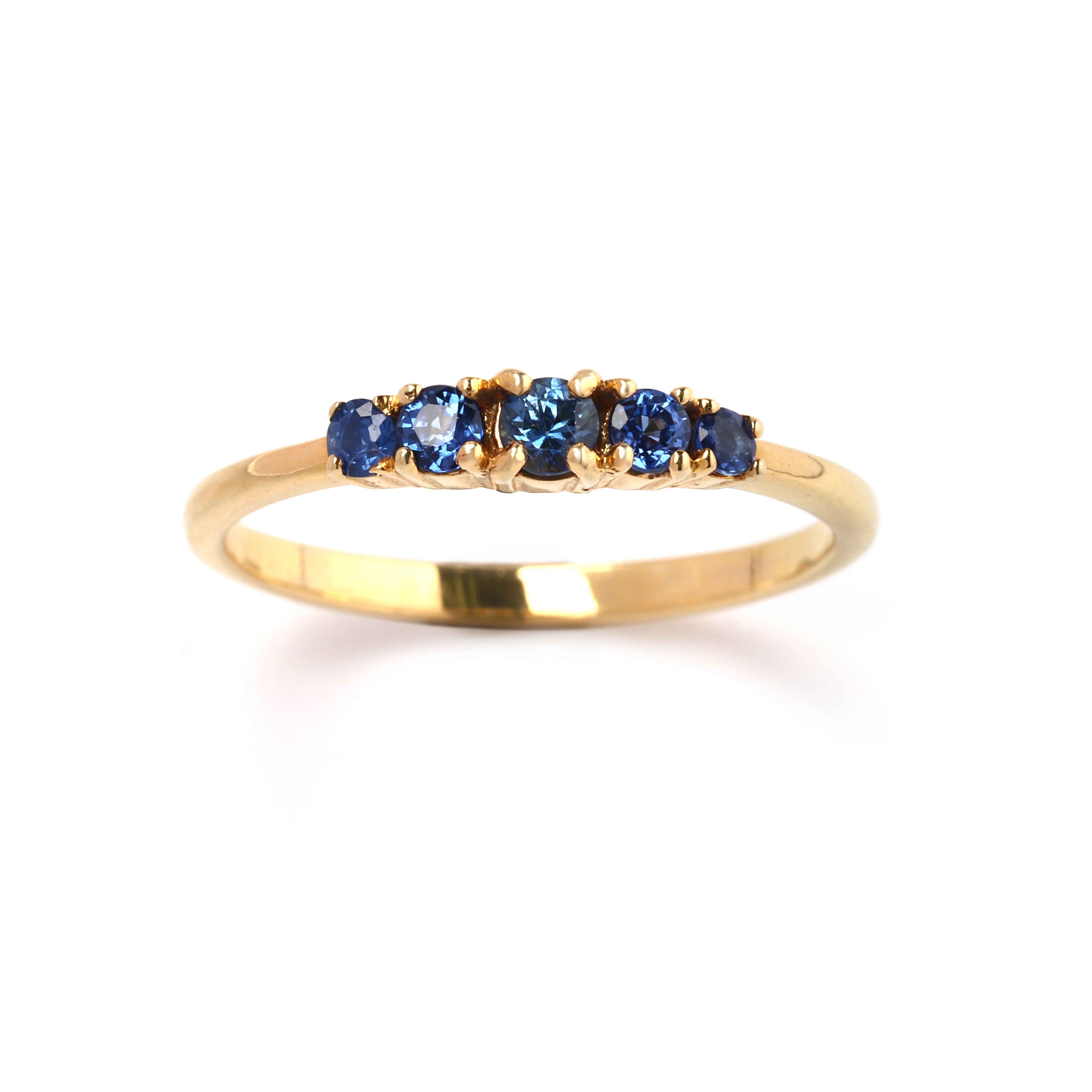 Close-up of 925 sterling silver blue sapphire ring with gold finish prong setting by Jewelry by Crimson