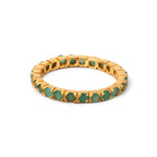 Gold ring with green gemstones, elegant and timeless design
