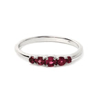 Sterling silver ring with five round red gemstones, elegant band design
