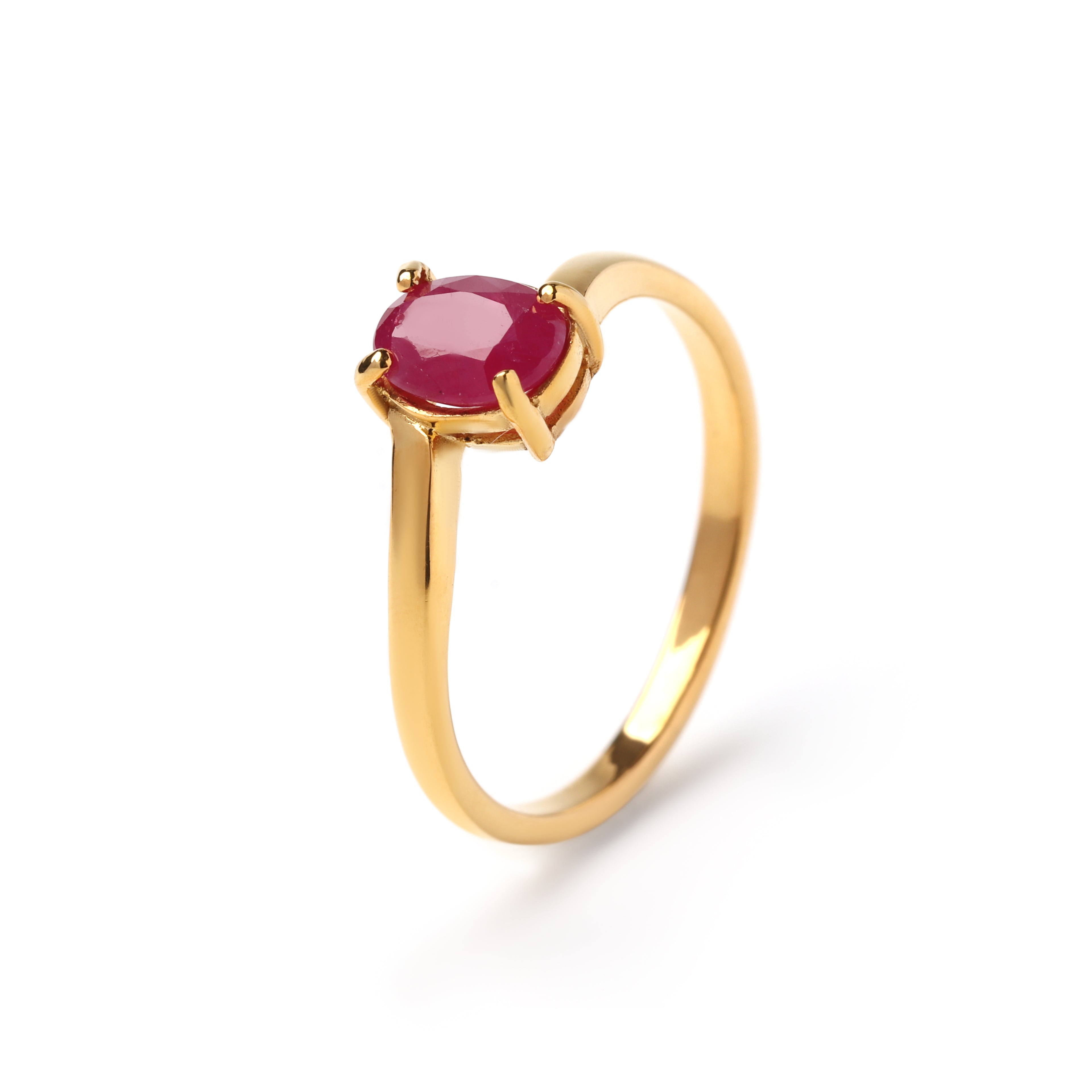 Close-up of ruby solitaire ring in 925 sterling silver with gold finish by Jewelry by Crimson