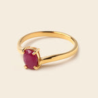 Gold ring with oval ruby gemstone, elegant minimalist design