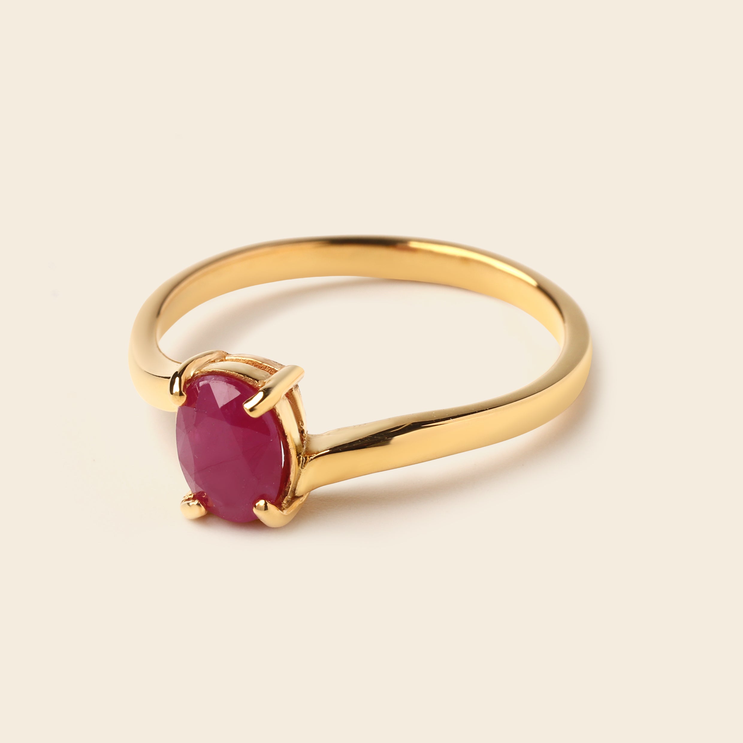Gold ring with oval ruby gemstone, elegant minimalist design