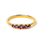 Gold ring with five round amethyst gemstones, elegant band design