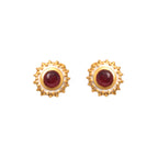 Gold stud earrings with red gemstones and textured white enamel border