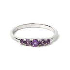 Sterling silver ring with five purple amethyst gemstones, elegant band design