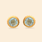 Gold-tone stud earrings with faceted light blue gemstones, elegant silver jewelry design