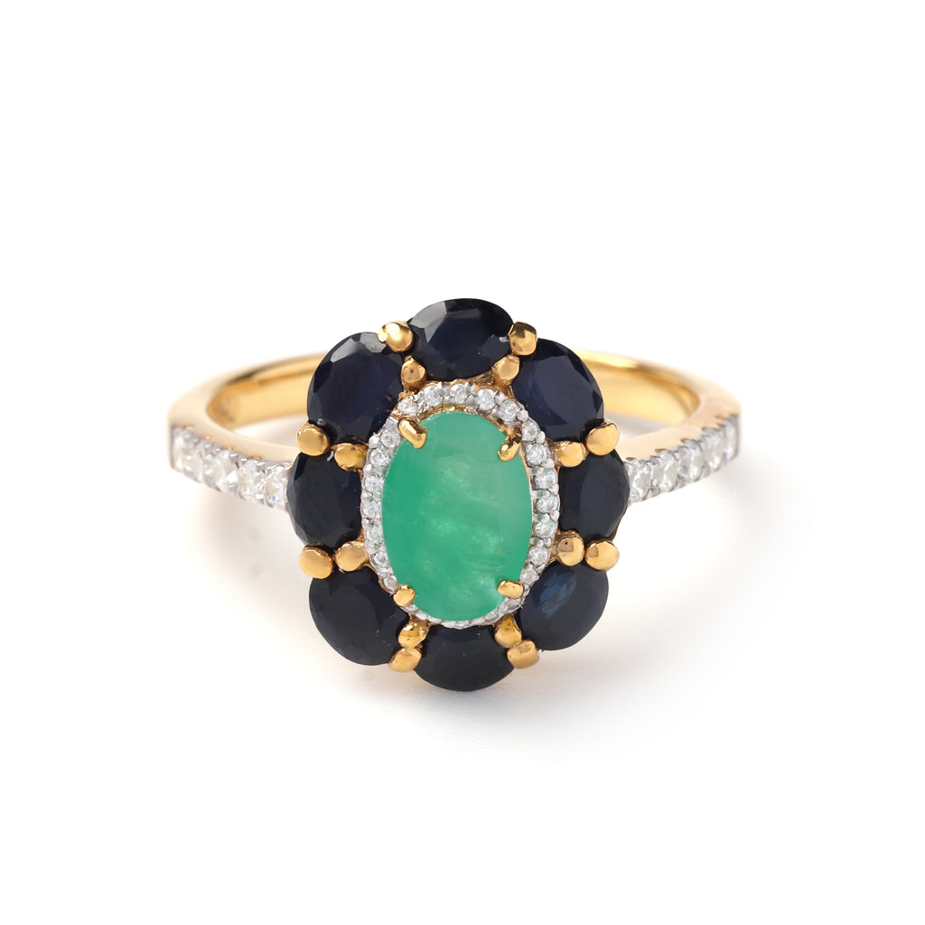 Close-up of emerald sapphire cluster ring in 925 sterling silver with gold finish by Jewelry by Crimson
