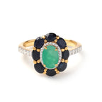 Emerald and sapphire flower ring with diamond accents in gold setting
