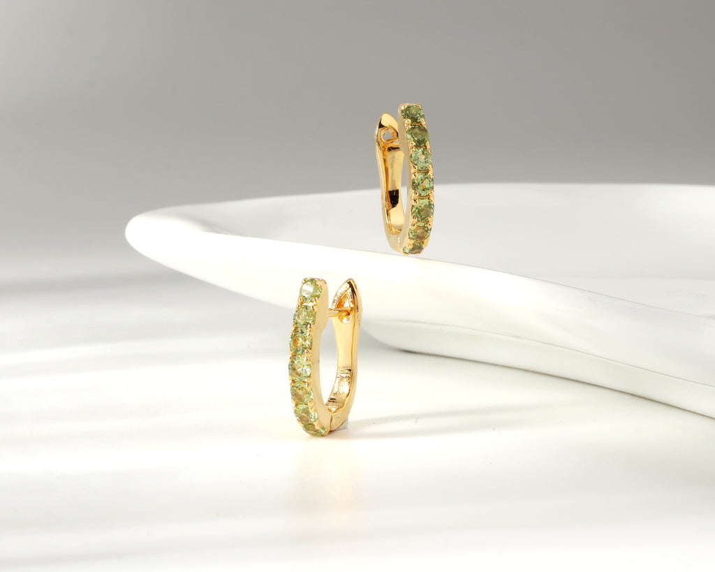 Green peridot gold hoop earrings — side view