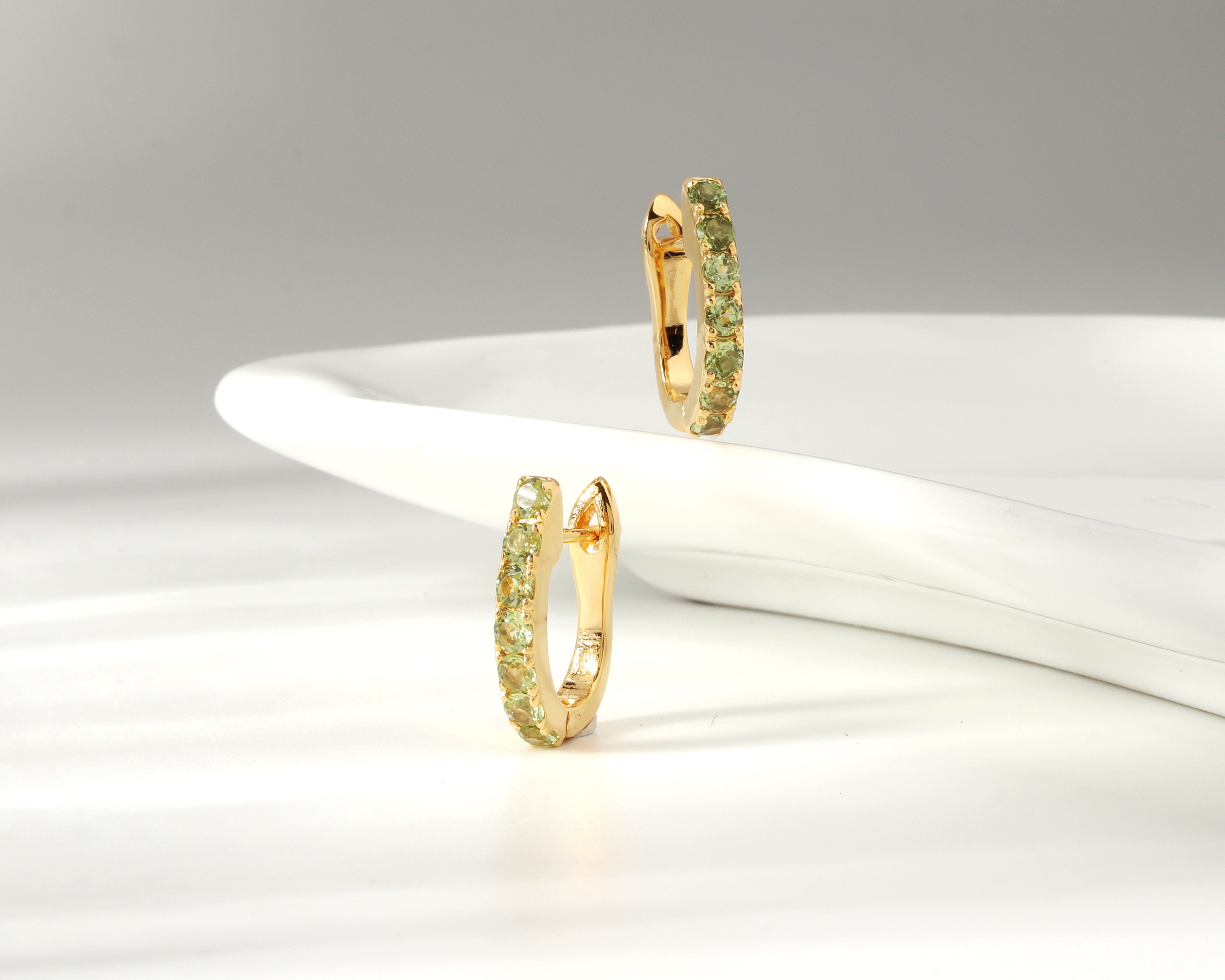 Green peridot gold hoop earrings — side view