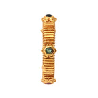 Gold ring with textured bands and three gemstones: black, green, and red