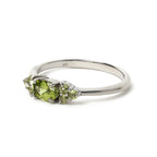 925 sterling silver ring with oval peridot and small green gemstones, elegant handcrafted design