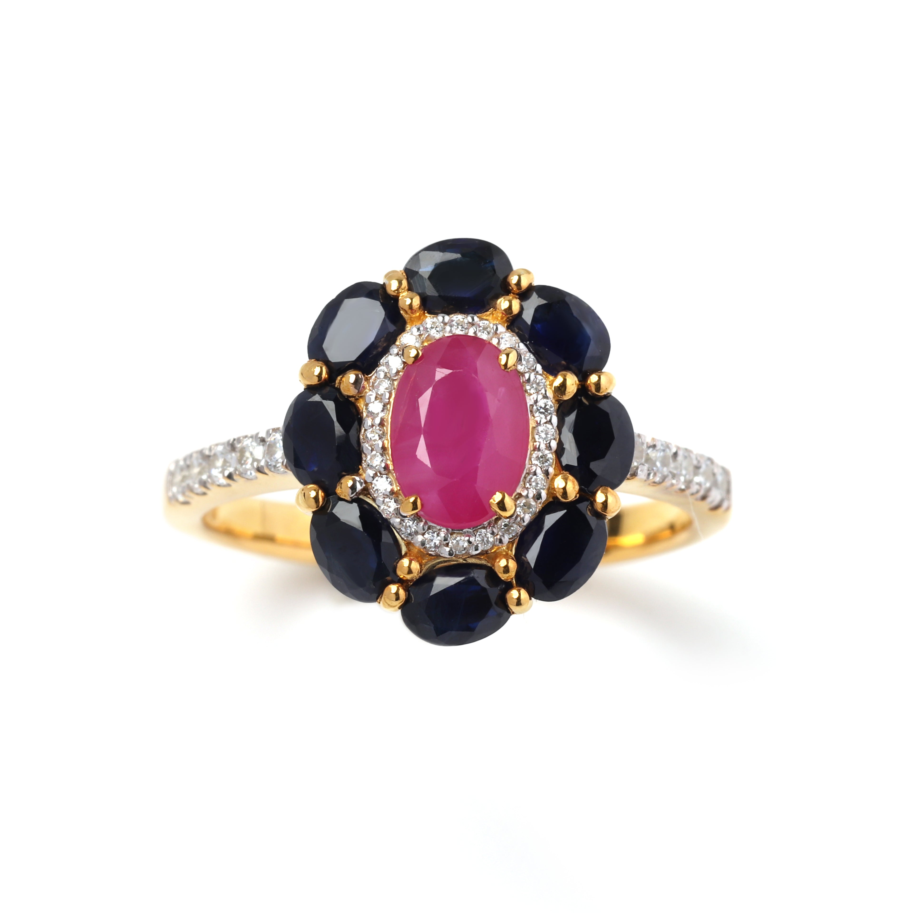 Close-up of ruby and sapphire halo ring in 925 sterling silver with gold finish by Jewelry by Crimson