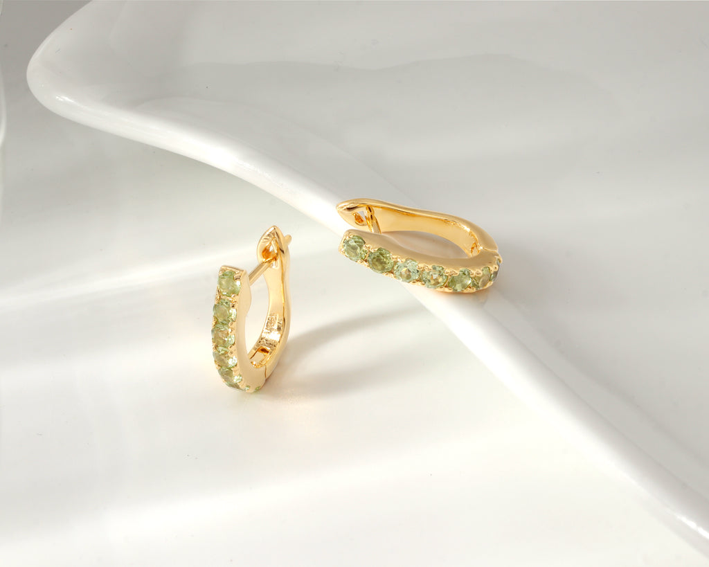 Peridot huggie hoop earrings in 18K gold — display view