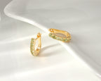 Peridot huggie hoop earrings in 18K gold — display view