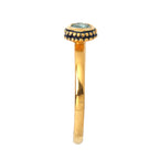 Gold ring with blue gemstone and black enamel detailing, elegant handcrafted jewelry design