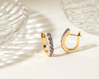 Blue-violet tanzanite gold hoop earrings — side view