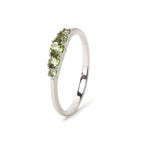 Sterling silver ring with five round peridot gemstones, elegant stackable design
