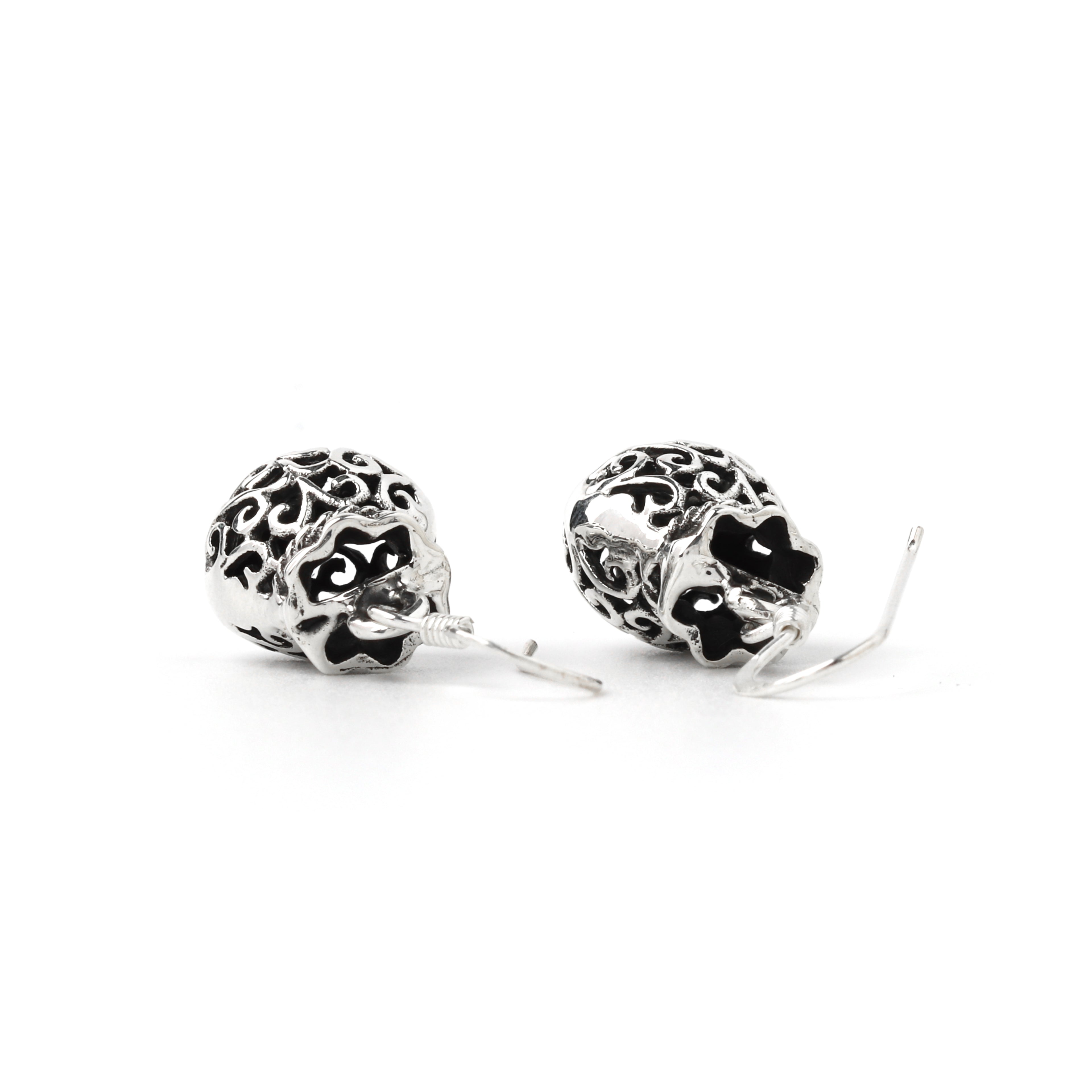 Elegant filigree dangle earrings with polished silver finish