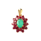 Elegant gold pendant with oval emerald center surrounded by ruby gemstones, handcrafted luxury jewelry