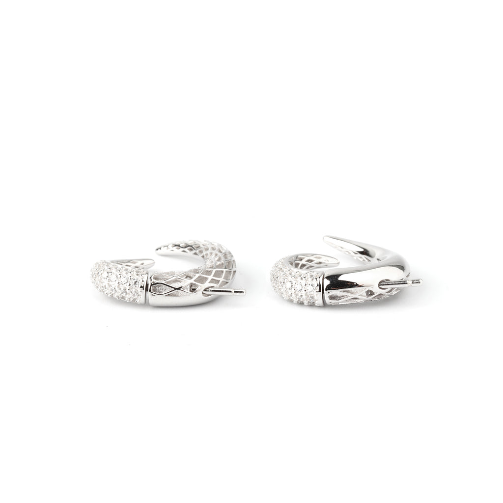 Detail shot of pavé-style texture and sculpted curve on sterling silver earrings