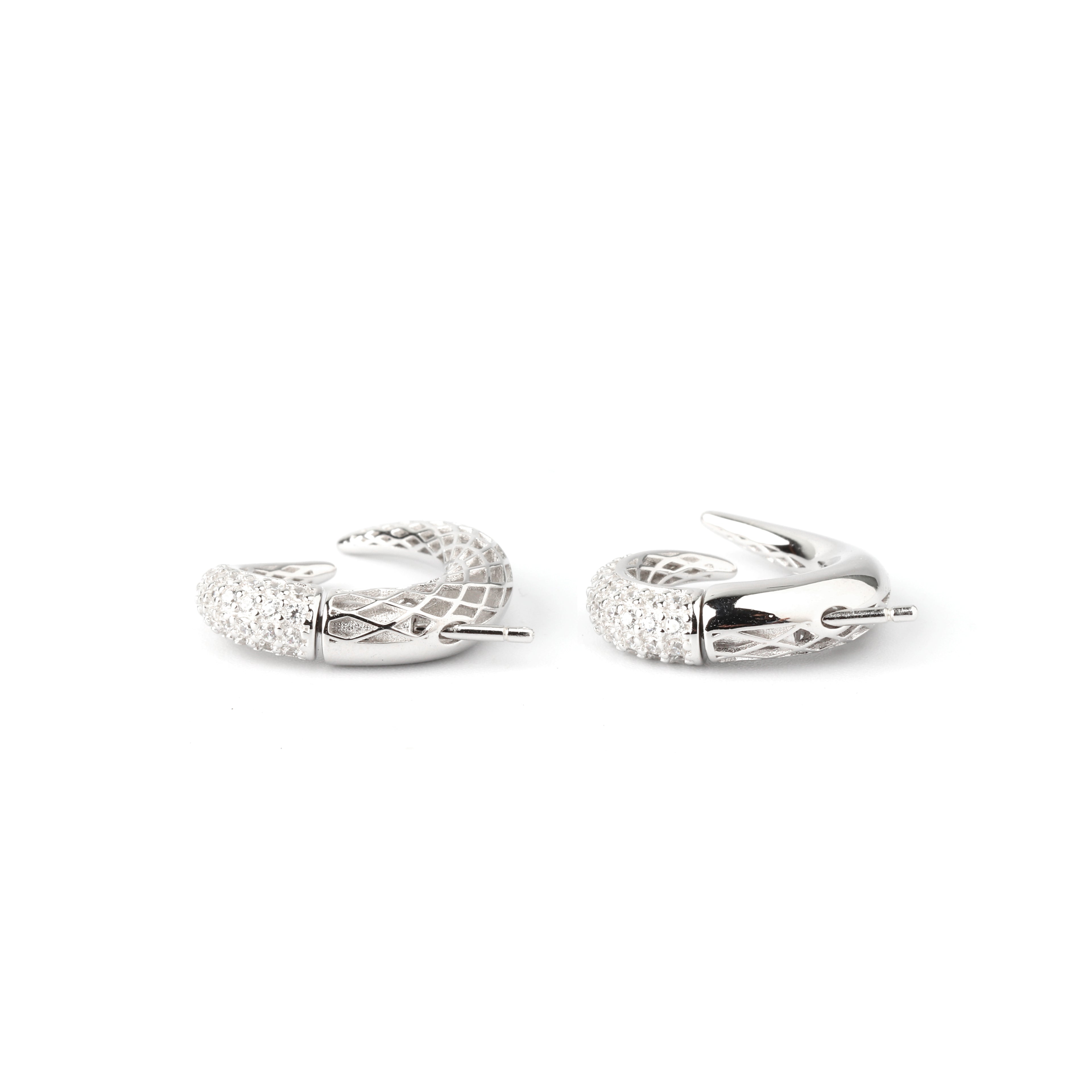 Detail shot of pavé-style texture and sculpted curve on sterling silver earrings