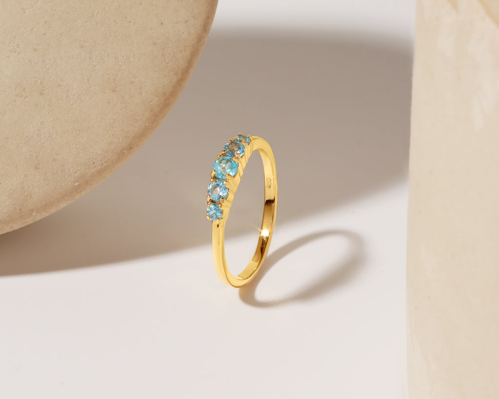 Sky-blue topaz gold stacking ring — front view