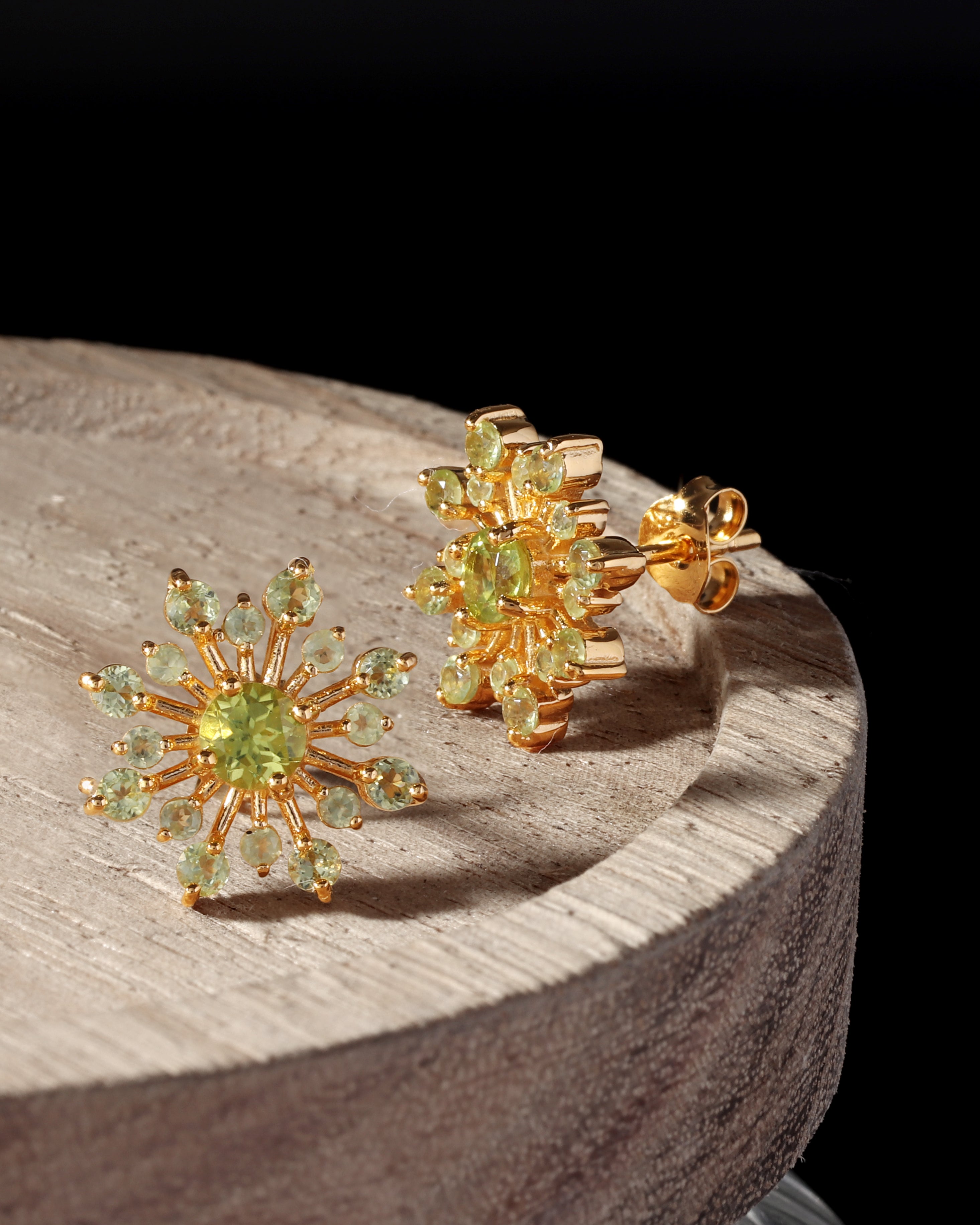 Flower-inspired peridot gemstone studs in gold — pair view