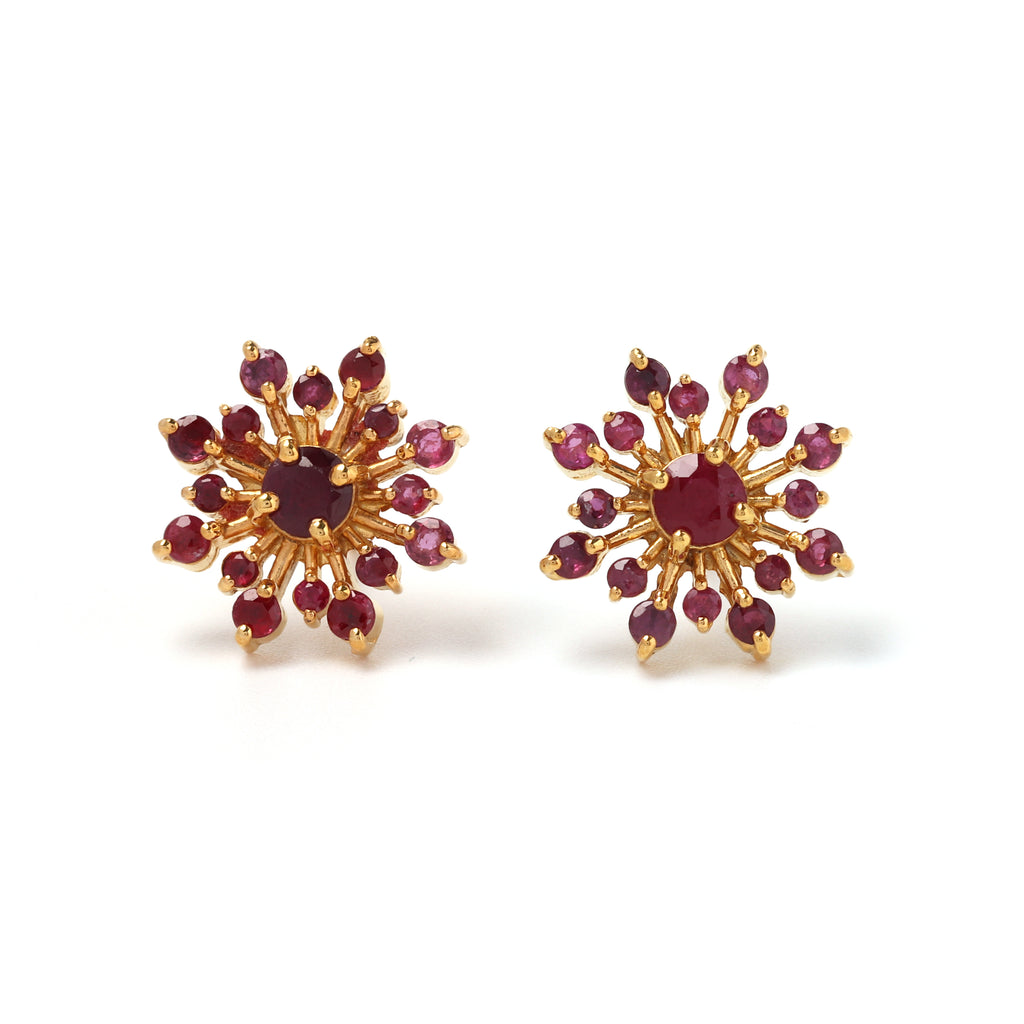 Close-up of ruby stud earrings in 925 sterling silver with gold finish by Jewelry by Crimson
