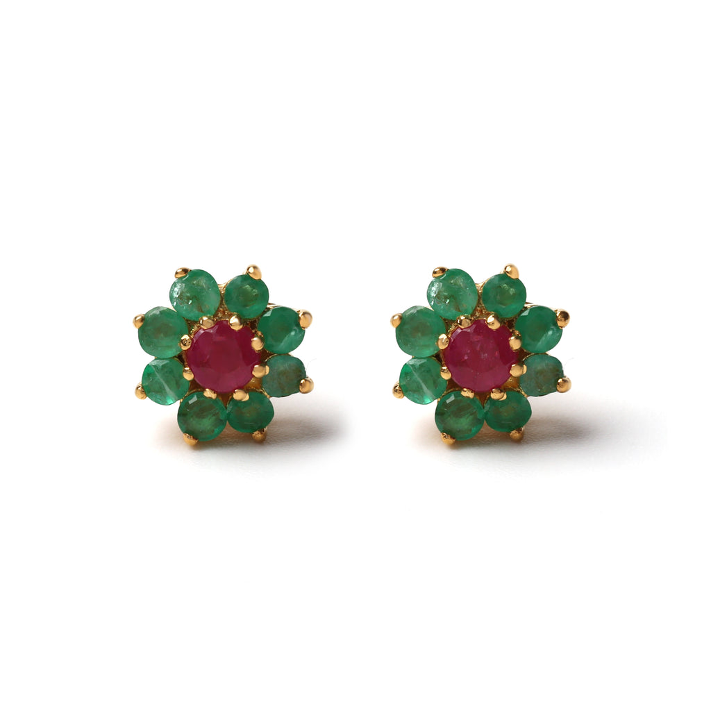 Close-up of 925 sterling silver stud earrings with ruby center and emerald halo, gold finish by Jewelry by Crimson