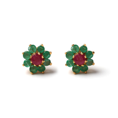 Close-up of 925 sterling silver stud earrings with ruby center and emerald halo, gold finish by Jewelry by Crimson
