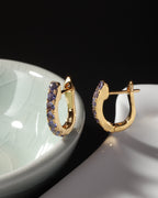 Gold huggie earrings with natural tanzanite — pair view