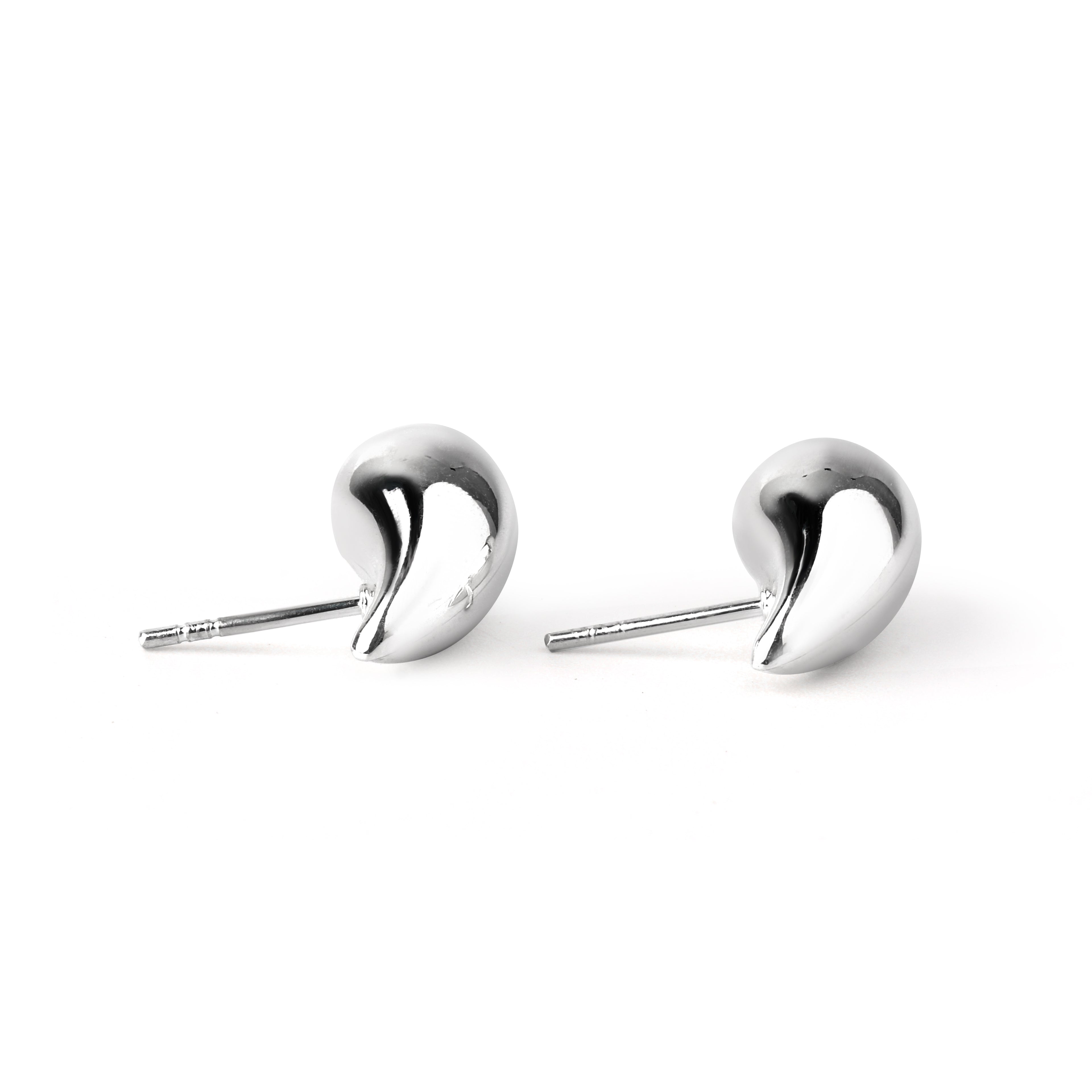 Detailed smooth surface texture of polished silver drop earrings by Jewelry by Crimson